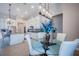 Bright dining area featuring a glass table, white chairs, and pendant lighting near the kitchen at 4206 Tour Trce, Land O Lakes, FL 34638
