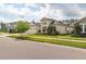 Lovely exterior view showcases manicured lawn, mature tree, and modern architectural design of the home at 4206 Tour Trce, Land O Lakes, FL 34638