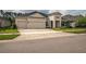 Charming home featuring a three-car garage and landscaped front yard at 4206 Tour Trce, Land O Lakes, FL 34638