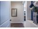 Hallway leading to a bathroom, featuring a decorative mirror and a floral arrangement on a shelf at 4206 Tour Trce, Land O Lakes, FL 34638