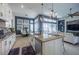 Open-concept kitchen with large island, adjacent to dining and living areas, creating a seamless and social space at 4206 Tour Trce, Land O Lakes, FL 34638