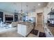 Spacious kitchen with granite counters, stainless appliances, island with seating, and view to living room at 4206 Tour Trce, Land O Lakes, FL 34638