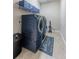 Laundry room with front-load washer and dryer, overhead storage, and a stylish laundry-themed floor mat at 4206 Tour Trce, Land O Lakes, FL 34638