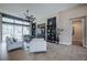 Inviting living room with large windows, ceiling fan, stone accent wall and plush white seating at 4206 Tour Trce, Land O Lakes, FL 34638