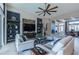 Spacious living room with large ceiling fan, featuring a stone accent wall and seamless flow to the dining room at 4206 Tour Trce, Land O Lakes, FL 34638