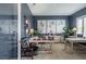 Home office with dark blue walls, natural light, and dual workstation setup at 4206 Tour Trce, Land O Lakes, FL 34638