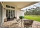 Spacious outdoor patio featuring brick flooring, patio furniture, and a lush lawn at 4206 Tour Trce, Land O Lakes, FL 34638