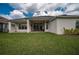Covered patio with outdoor seating for relaxing and entertaining in backyard at 4206 Tour Trce, Land O Lakes, FL 34638