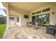 Beautiful outdoor patio area with brick floors, a tv, and sliding glass doors at 4206 Tour Trce, Land O Lakes, FL 34638
