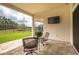 Outdoor patio featuring brick flooring, patio furniture, and a scenic view at 4206 Tour Trce, Land O Lakes, FL 34638