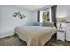 Cozy bedroom with a large window, gray curtains, and butterfly wall decor at 4215 E Bay Dr # 1701C, Clearwater, FL 33764