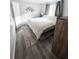 Neutral bedroom with modern décor, a large window, and wood-look floors at 4215 E Bay Dr # 1701C, Clearwater, FL 33764