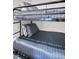 Close-up of a black metal bunkbed featuring comfy gray bedding and soft pillows at 4215 E Bay Dr # 1701C, Clearwater, FL 33764