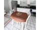 Bright dining area with white cabinets and a dining table with white chairs at 4215 E Bay Dr # 1701C, Clearwater, FL 33764