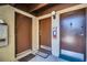 Three brown entry doors with an extinguisher on a light tan wall at 4215 E Bay Dr # 1701C, Clearwater, FL 33764