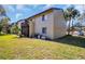 Exterior side view of the condo building with a balcony and well-kept lawn at 4215 E Bay Dr # 1701C, Clearwater, FL 33764