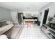 Open concept living space featuring tile floors, stainless appliances, and a dining area at 4215 E Bay Dr # 1701C, Clearwater, FL 33764