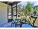 Relaxing screened-in patio area with outdoor seating and lush tropical views at 4215 E Bay Dr # 1701C, Clearwater, FL 33764