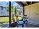 Screened patio with comfortable seating and a view of the lush landscaping at 4215 E Bay Dr # 1701C, Clearwater, FL 33764