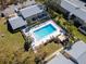 Aerial view of a sparkling pool with lounge chairs surrounded by lush landscaping and well-maintained buildings at 4215 E Bay Dr # 1701C, Clearwater, FL 33764