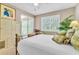 Bedroom boasts natural light, white shutters, and a decorative brass bed frame at 4266 Preserve Pl # 4266, Palm Harbor, FL 34685