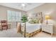 Comfortable bedroom with neutral tones, white shutters, and a decorative brass bed frame at 4266 Preserve Pl # 4266, Palm Harbor, FL 34685