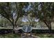 A Lansbrook Commons sign nestled amongst mature shade trees at the entrance to the park at 4266 Preserve Pl # 4266, Palm Harbor, FL 34685