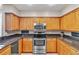 Well-equipped kitchen featuring stainless steel appliances, granite countertops, and ample cabinet space at 4266 Preserve Pl # 4266, Palm Harbor, FL 34685