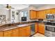 Stylish kitchen offering granite countertops, stainless steel appliances, and a breakfast bar at 4266 Preserve Pl # 4266, Palm Harbor, FL 34685