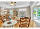 Bright and airy living room with stylish furnishings, plantation shutters, and access to a sunroom with a lush view at 4266 Preserve Pl # 4266, Palm Harbor, FL 34685