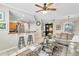 Open-concept living room with a kitchen bar, tile flooring, and comfortable seating, perfect for entertaining guests at 4266 Preserve Pl # 4266, Palm Harbor, FL 34685
