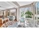 Bright sunroom featuring wicker seating, abundant natural light, and seamless integration with the main living area at 4266 Preserve Pl # 4266, Palm Harbor, FL 34685