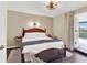 Cozy bedroom features hardwood floors, a rattan headboard, and access to a private balcony at 4312 Sunray Ct # 36, Tampa, FL 33615