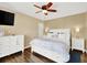 Charming bedroom with a ceiling fan, TV, wood floors, and white furniture at 4312 Sunray Ct # 36, Tampa, FL 33615