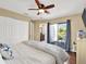 Bedroom with balcony access, ceiling fan, ensuite bathroom, and closet at 4312 Sunray Ct # 36, Tampa, FL 33615