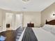 Bedroom with hardwood floors, walk-in closet, and a decorative rattan headboard at 4312 Sunray Ct # 36, Tampa, FL 33615