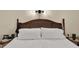Bedroom close-up showing rattan headboard, white bedding, and side table decor at 4312 Sunray Ct # 36, Tampa, FL 33615