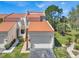 Exterior of home with attached garage, manicured landscaping, and a distinctive orange roof at 4312 Sunray Ct # 36, Tampa, FL 33615