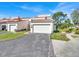 Charming townhome featuring a private garage, a driveway, and lush landscaping with mature trees at 4312 Sunray Ct # 36, Tampa, FL 33615