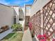 Exterior view of the home's entrance featuring a metal gate, walkway, and landscaping at 4312 Sunray Ct # 36, Tampa, FL 33615