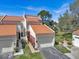 Exterior view of the home featuring a well manicured lawn, landscaping, and a two car garage at 4312 Sunray Ct # 36, Tampa, FL 33615