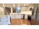 Bright, updated kitchen with stainless steel appliances and white cabinets; view to adjacent living space at 4312 Sunray Ct # 36, Tampa, FL 33615