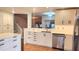 Bright updated kitchen with stainless dishwasher and a view of the adjacent staircase and living area at 4312 Sunray Ct # 36, Tampa, FL 33615
