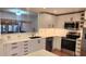 Modern kitchen featuring stainless appliances, white cabinetry, and sleek black hardware, open to the dining area at 4312 Sunray Ct # 36, Tampa, FL 33615