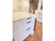 Detail of kitchen island featuring white cabinets, sleek black hardware, and stainless trash can at 4312 Sunray Ct # 36, Tampa, FL 33615