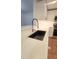 Close-up of modern kitchen featuring a black sink, white quartz counters, and stainless steel appliances at 4312 Sunray Ct # 36, Tampa, FL 33615
