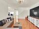 Open-concept living room with tile flooring, a large TV, and seamless flow into other areas of the home at 4312 Sunray Ct # 36, Tampa, FL 33615