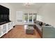Well-lit living area with sliding glass doors to a patio and comfortable seating arrangements at 4312 Sunray Ct # 36, Tampa, FL 33615