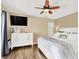 Serene main bedroom features wood floors, a white dresser, and a ceiling fan for comfortable living at 4312 Sunray Ct # 36, Tampa, FL 33615