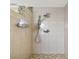 Walk in shower with tile surround, multiple shower heads, and soap dispenser at 4312 Sunray Ct # 36, Tampa, FL 33615